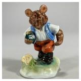 Herend Bear Figure | Porcelain Herend bear holding a jar of Mez, marked on the bottom. - l. 3.5 x h.