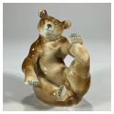 German Porcelain Bear | Playful seated bear with German makers mark on bottom. - l. 5.5 x h. 5.75 in