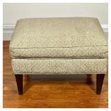 Crate & Barrel Ottoman | Cushioned ottoman with textured and patterned fabric upholstery on tapering