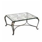 PIERRE DEUX LOW FORM COFFEE TABLE | Metal scrollwork with gilt highlights, glass top - l. 35 x w. 43