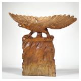 FOLK ART EAGLE WOOD CARVING | Carved wood sculpture of an eagle perched on a rock formation, no appa