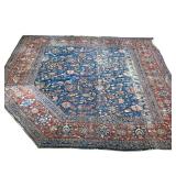 ANTIQUE HERIZ/ SERAPI RUG | Floral overall pattern on a blue ground within a red border, cut and rea