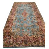 ANTIQUE SKY BLUE KIRMAN PERSIAN CARPET | Early 20th century, having a blue ground with beige, red, a