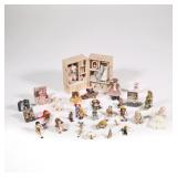 MINIATURE DOLL TRUNKS & DOLLS | A collection of miniature toy dolls and wooden puppets for a dollhou