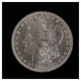 1885-O MORGAN SILVER DOLLAR | Enclosed in an envelope describing it as "borderline MS 65"