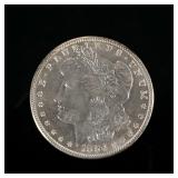1886-P MORGAN SILVER DOLLAR | In a folding envelope describing it as "borderline MS 65".