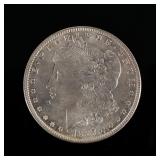 1887-P MORGAN SILVER DOLLAR | In a folding envelope describing it as "borderline MS 65"