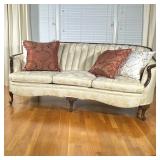 ANTIQUE TUFTED SOFA | Antique Victorian 3-cushion sofa having curved tufted back over carved cabriol