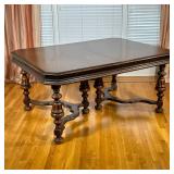 ANTIQUE CARVED WOOD DINING TABLE | Having carved wood refinished top over spindle carved & fluted le