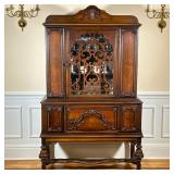 ANTIQUE CHINA CABINET | Having carved wood front with glass door over carved wood cabinet with spind