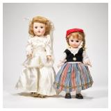 (2pc) PAIR PORCELAIN DOLLS | Includes; girl in wedding dress and girl in traditional European wear. 