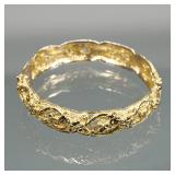 GOLD-TONE HARD BRACELET | Designed as a hinged hard bracelet decorated with flowers and scrolls pier