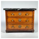 MINIATURE CHEST with MARBLE TOP | Chest with three inlaid drawers on bun feet, having brass pulls & 