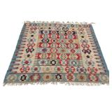 FLAT WOVEN KILIM RUG | Having colorful medallions on alternating tiles of color over a beige ground,