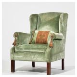 Velvet Upholstered Wingchair | Finely upholstered in green velvet with scroll arms, tassels on the h