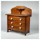 MINIATURE CHEST WITH BACKSPLASH | Miniature three drawer chest, each drawer with double porcelain pu