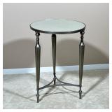 ROUND MIRRORED SIDE TABLE | End table with a mottled mirrored top over a silvered metal base with x-