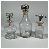 (3pc) GLASS BOTTLES WITH PEWTER STOPPERS | Decorative glass bottles with figural pewter stops. - h. 