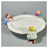 FUN LOTUS ART CERAMIC CAKE PLATTER | By Lotus, with three figures around the rim. - h. 5 x dia. 14 i