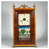 BURLWOOD SHELF CLOCK | Contrasting burlwood case with mounted brass feet, the face with Roman numera