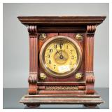 SMALL WOODEN SHELF CLOCK | Carved wood shelf clock with fluted sides, the face with Arabic numeral m
