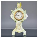 AMERICAN PORCELAIN CLOCK | Sculpted porcelain with floral decoration and gilt highlights, crested by