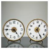 (2pc) PAIR PORCELAIN & BRASS EASEL CLOCKS | Each having a gilt frame with folding easel back, the fa
