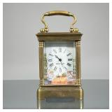 FRENCH PORCELAIN CARRIAGE CLOCK | Brass carriage clock of small size with five beveled glass panels 