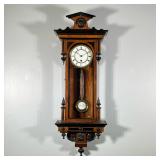 “RA” VIENNA REGULATOR WALL CLOCK | White enameled face with black Roman numeral markers and an ename