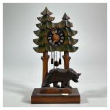 GERMAN WOOD-CARVED CLOCK | Grieshaber carved and painted with two trees and a bear, the face marked 