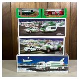 (5pc) [nib] Hess Trucks | Including a toy truck and race car, a space shuttle with satellite, a heli