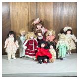 (10pc) Porcelain Head Dolls | Some on stands, including a Noble Heritage Collection doll in red velv