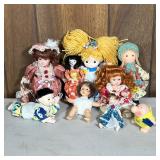 (9pc) Small Porcelain & Other Dolls | Including a reach for the stars applause doll, a fabric doll i