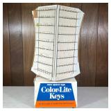 VINTAGE ENAMELED METAL ROTATING KEY DISPLAY | With advertisements for “new space age, color-light ke