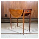 Pembroke Table | Inlaid in contrasting woods, having an extending round top over square tapering leg