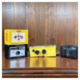 (3pc) Film Cameras | Including a Kodak Instamatic 104 / Camera with original box, a yellow Minolta W
