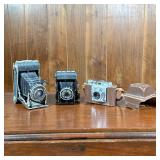 (3pc) Film Cameras | Including a Zeiss Ikon camera, a Primus Prontor II, and an Olympus 35 in leathe
