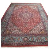 EARLY 20th CENTURY PERSIAN KASHAN CARPET | Central medallion on a red ground within blue and red bor
