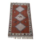 SOUTHWEST RUG | Three medallion rug with figures on a rust ground within a patterned border. - w. 36