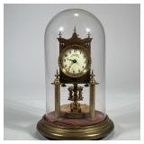 GLASS DOMED "ANNIVERSARY" CLOCK | Glass domed brass clock with ceramic face marked "Anniversary Trad