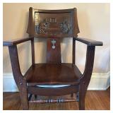 Carved Monk Armchair - 1 of 2 | Antique carved oak armchair featuring back panel artwork of two men 