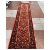 Red Runner Rug | Red runner rug with flourishing details.