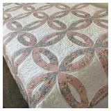 DOUBLE WEDDING RING PATTERNED QUILT | With pink and blue flower printed fabrics.