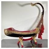 BURMESE SAUNG-GUAK HARP | Burmese Saung-guak harp on stand with gilt decoration. - h. 32.5 x w. 8 x 