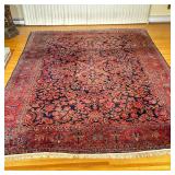 Persian/Sarouk Area Rug (Large) | Persian/Sarouk style red and navy area rug with white fringe. - w.