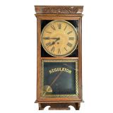 Ingraham Regulator Wall Clock | In a carved oak case, the face signed by the E. Ingraham Co., Bristo