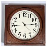 Counter Clockwise Wall Clock | Square wall clock in an oak case, having a white dial with Arabic num