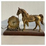 United Shelf Clock | Clock with hors, the face with Arabic numerals and signed "UNITED," surrounded 