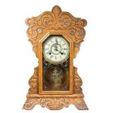 New Haven Carved Shelf Clock | An antique parlor mantle clock with ornate carved case, the face sign