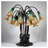 AFTER TIFFANY STUDIOS "HIGH POND LILLIES" TABLE LAMP | A 20th century copy, bronze base sprouting "f